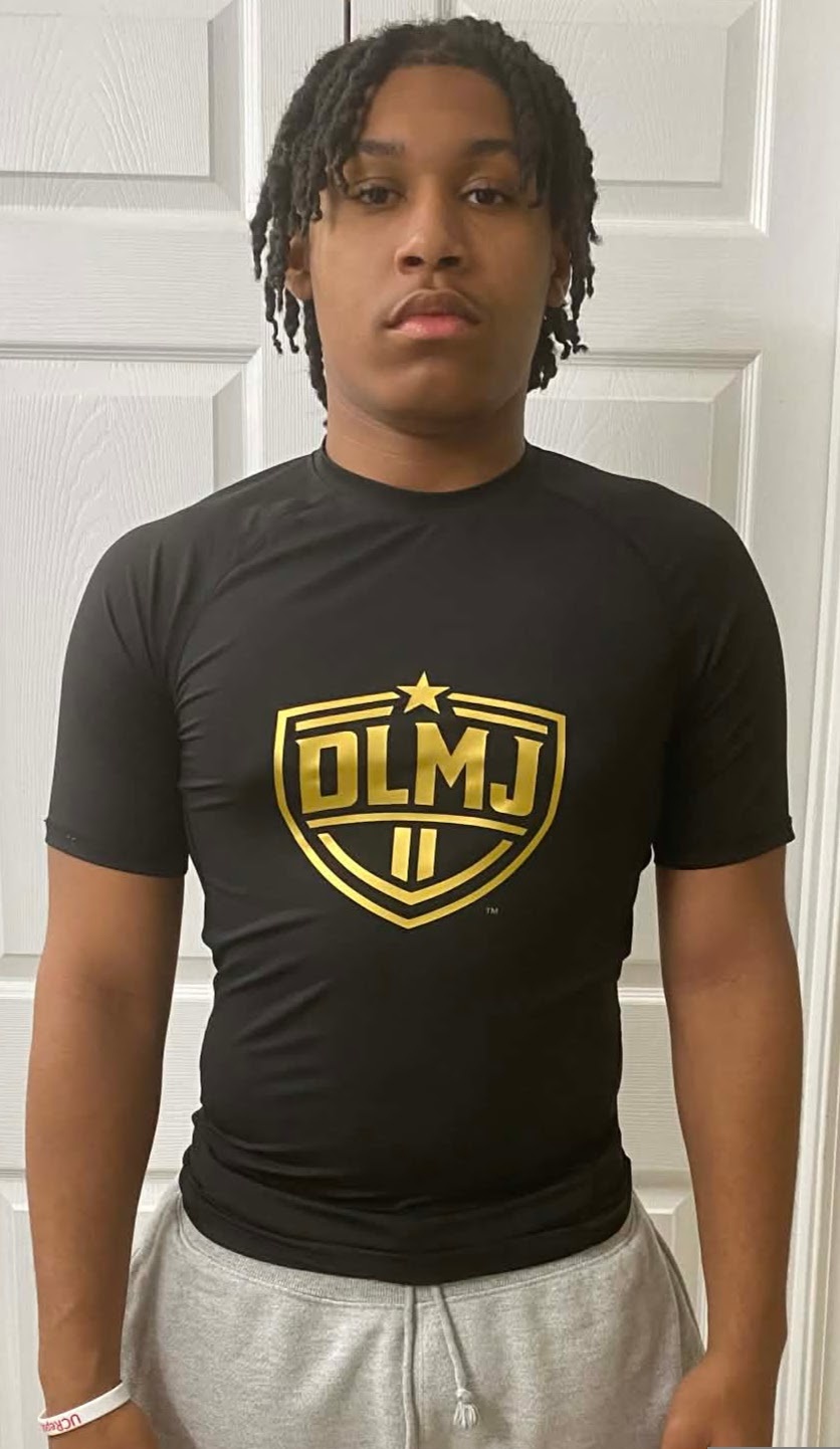 Dantae wearing the front of the DLMJ Athletics shirt